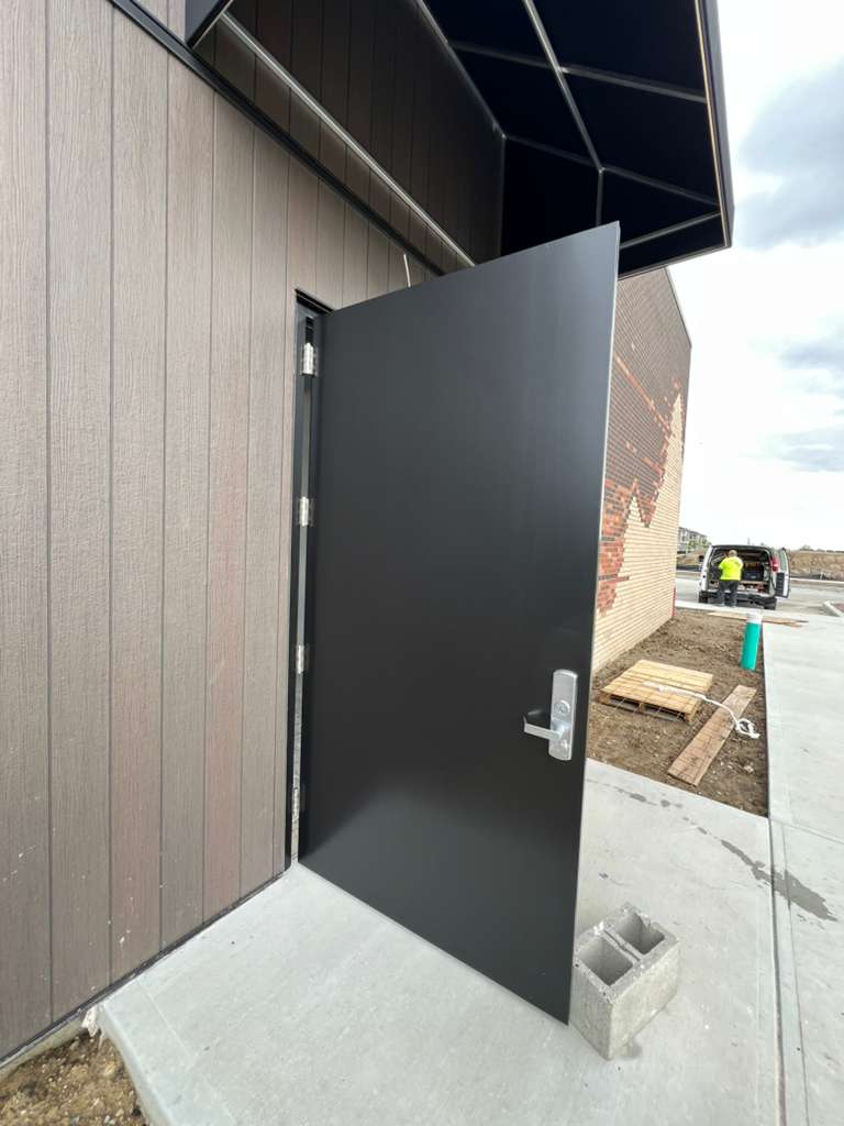 Commercial building entrance with finished siding and brick